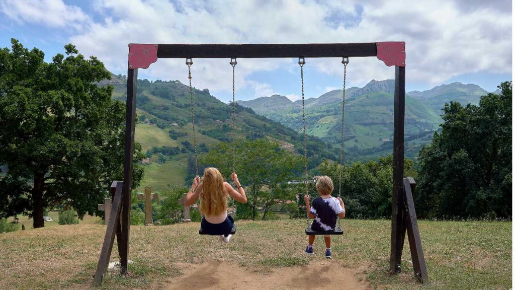 Two kids on a swing